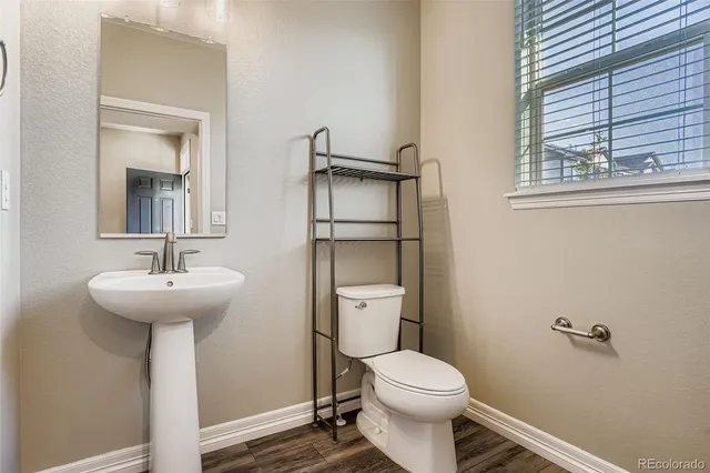 a bathroom with a sink toilet and a mirror