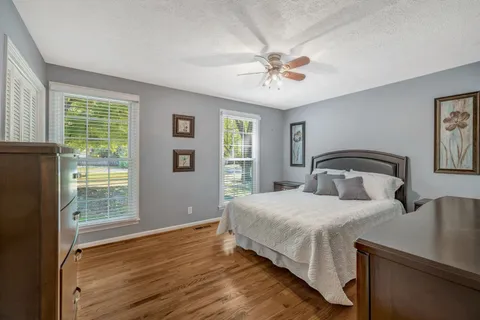 a bedroom with a large bed and a window