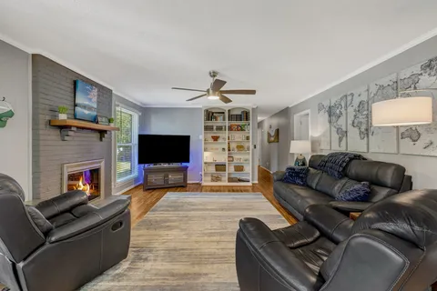 a living room with furniture and a fireplace