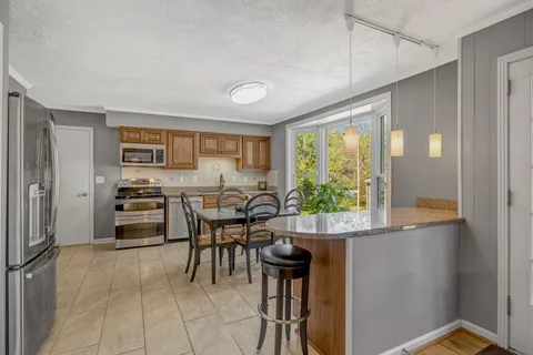 a view of a dining room with furniture window and outside view