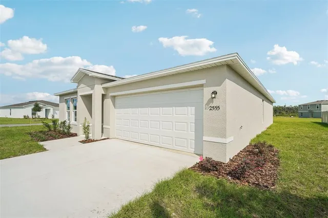 a view of a house with a yard and garage