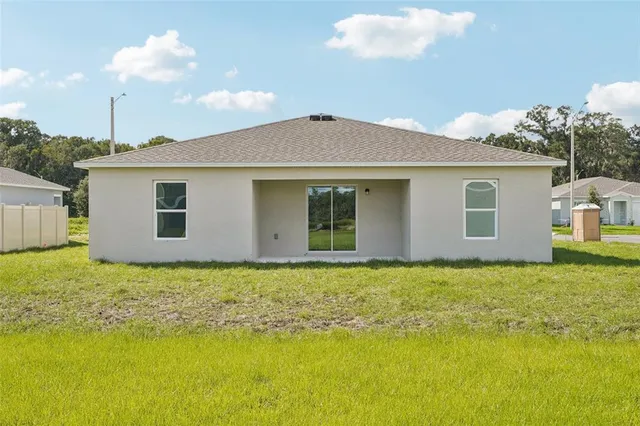 a view of a house with a backyard