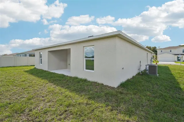 a view of a backyard with plants and a big yard