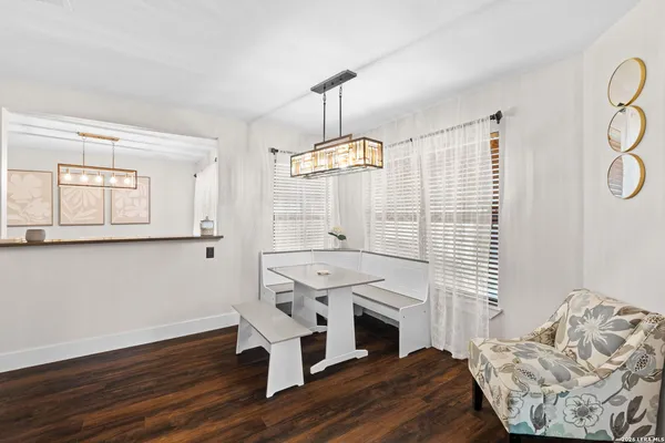 a view of a livingroom with furniture window wooden floor and front door