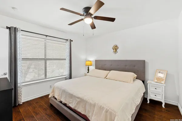 a bedroom with a large bed and a window