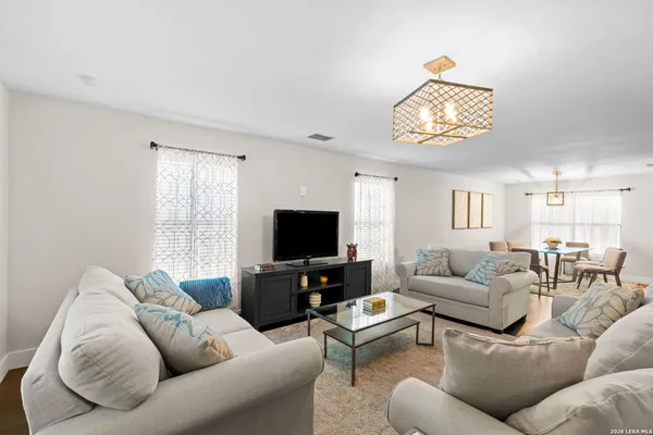 a living room with furniture a large window and a flat screen tv