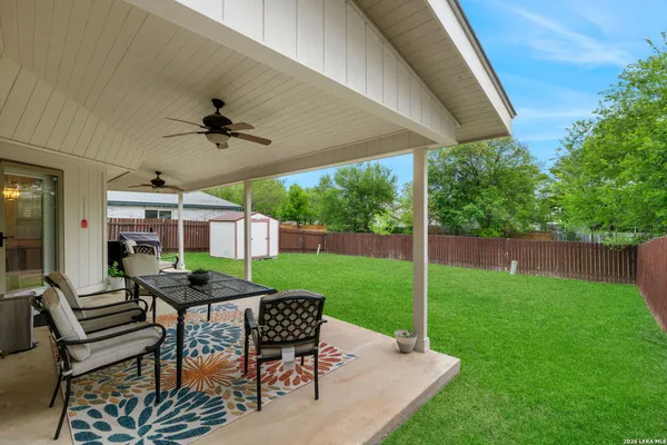 a view of a patio with a table chairs and a backyard