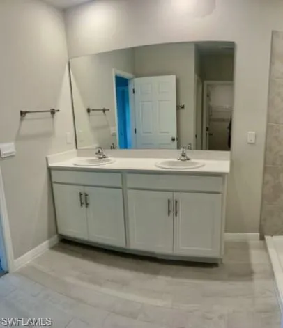 a bathroom with a sink and a mirror
