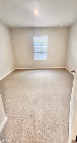 an empty room with a empty space and window