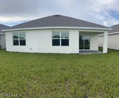a view of house with backyard
