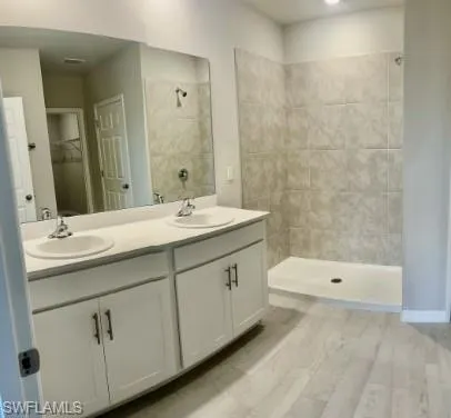 a bathroom with a double vanity sink and mirror