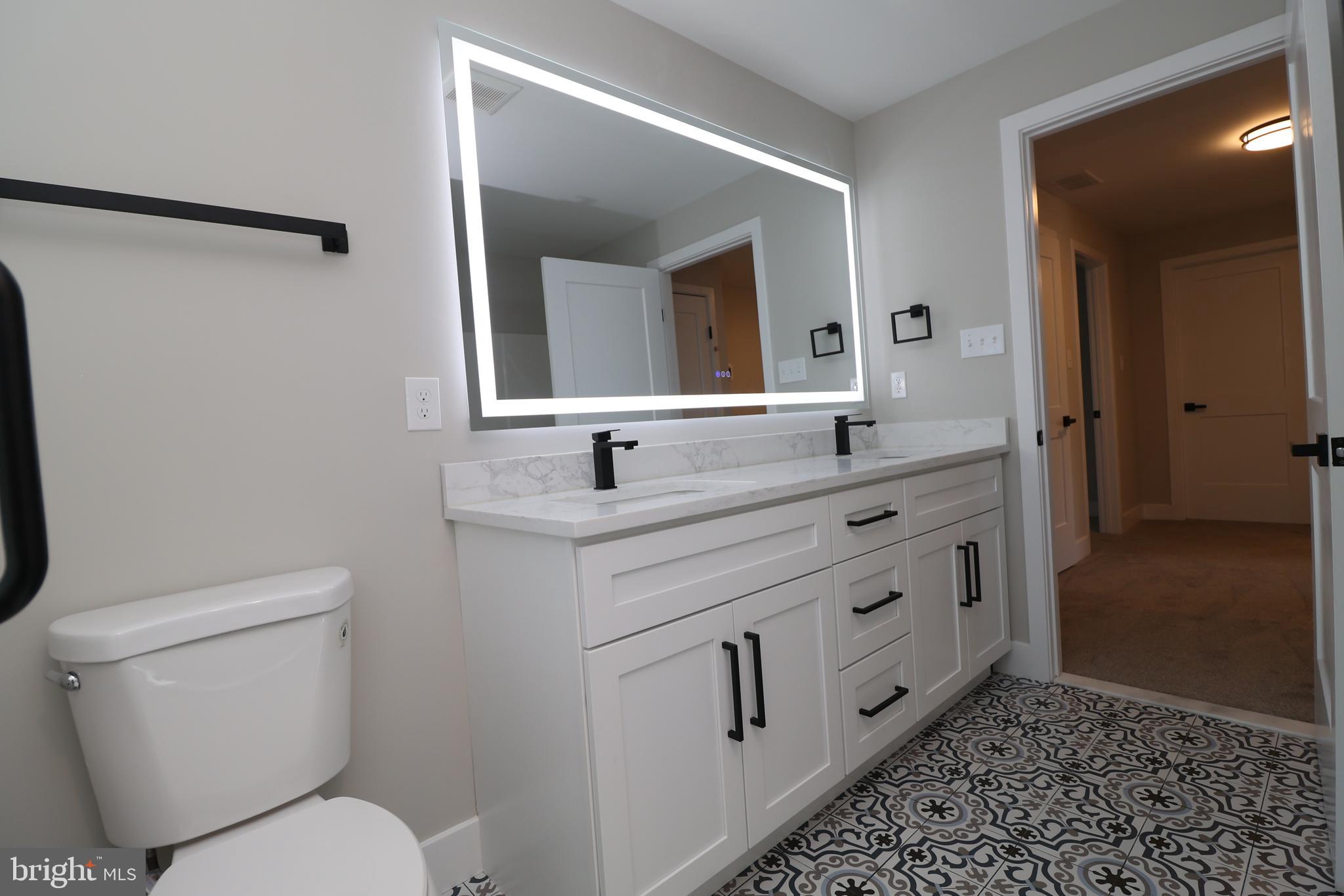 610 Burton Road Oreland, PA 19075 - Photo 57 of 77 Hall Bath with Dual Vanity and Lighted Mirror
