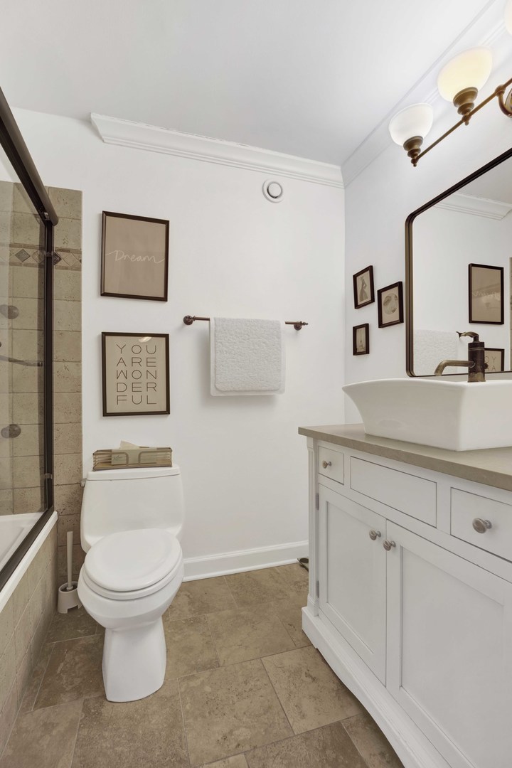 30 East Huron Street, Unit 3206 Chicago, IL 60611 - Photo 14 of 29 a bathroom with a toilet sink and mirror