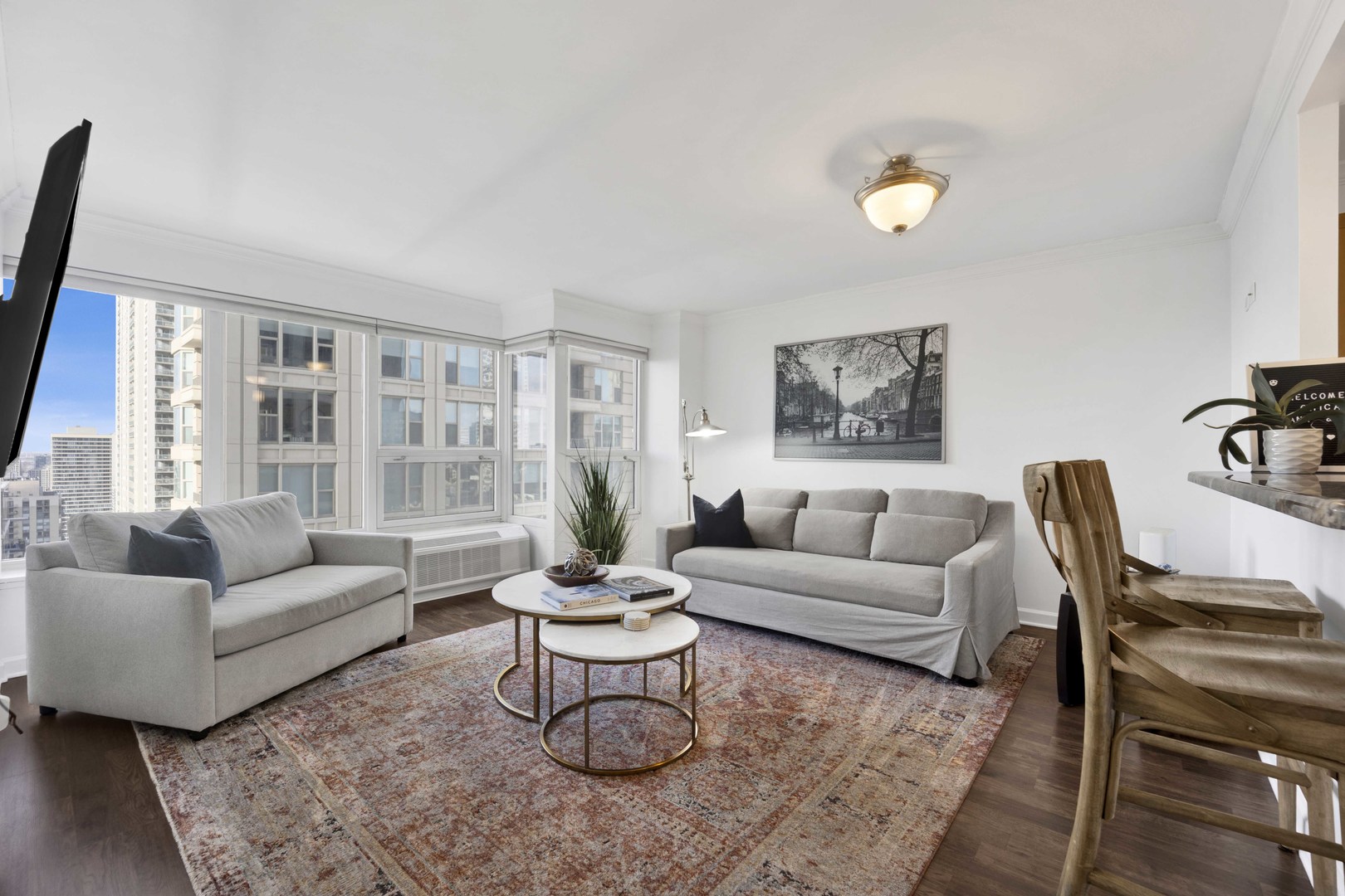 30 East Huron Street, Unit 3206 Chicago, IL 60611 - Photo 3 of 29 a living room with furniture wooden floor and a large window