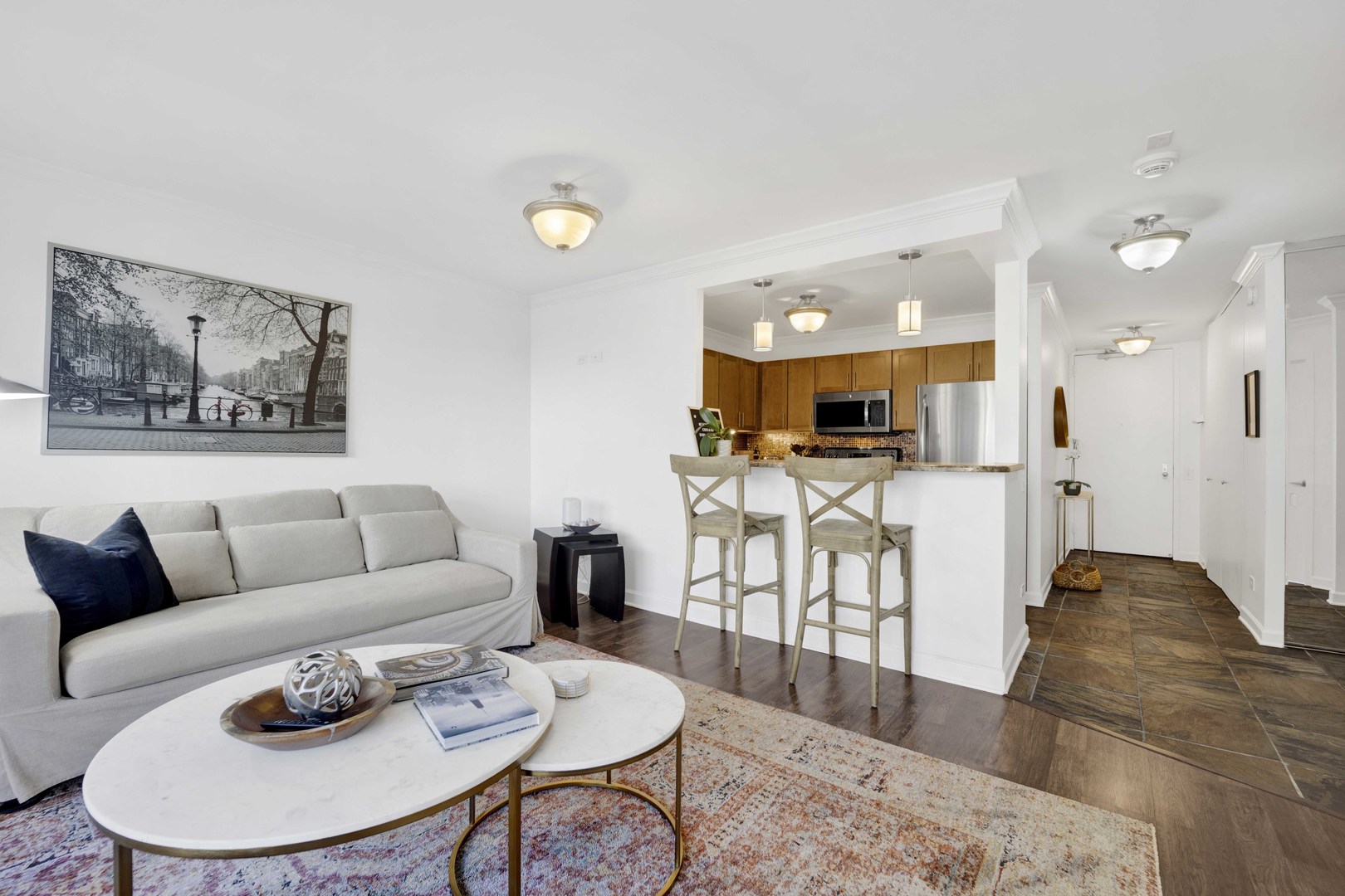 30 East Huron Street, Unit 3206 Chicago, IL 60611 - Photo 5 of 29 a living room with furniture and a dining table with wooden floor