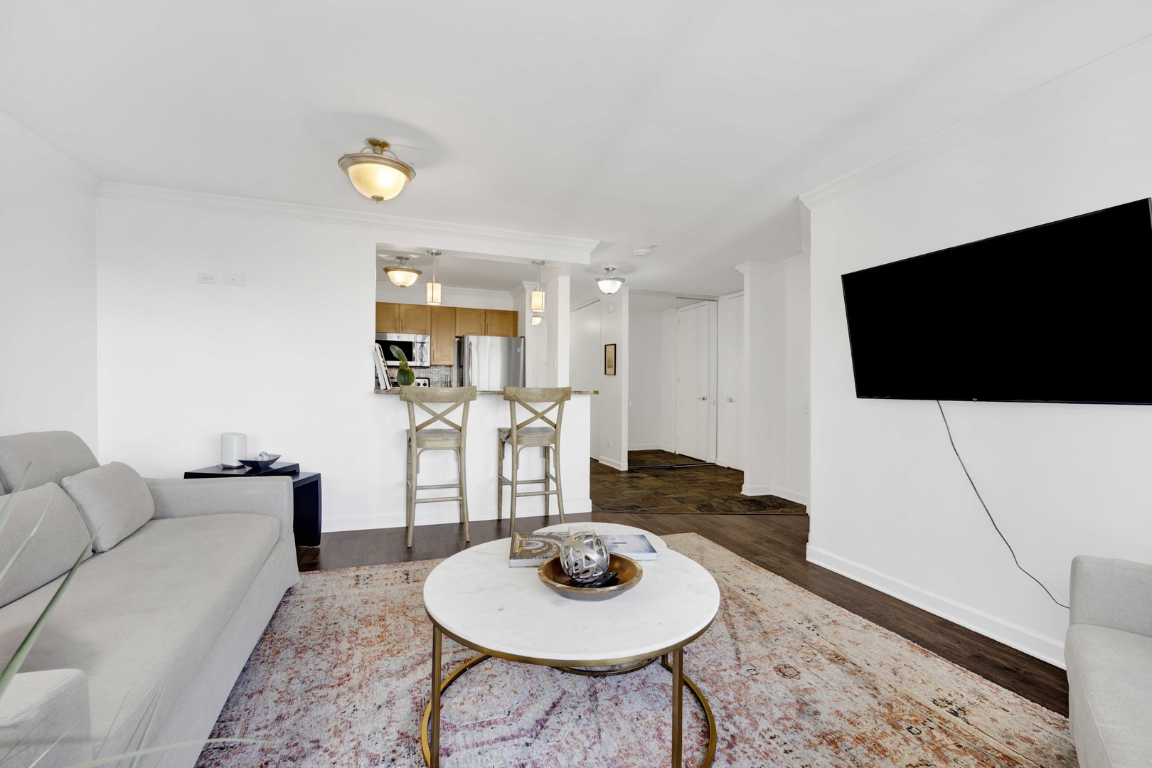 30 East Huron Street, Unit 3206 Chicago, IL 60611 - Photo 6 of 29 a living room with furniture and a flat screen tv