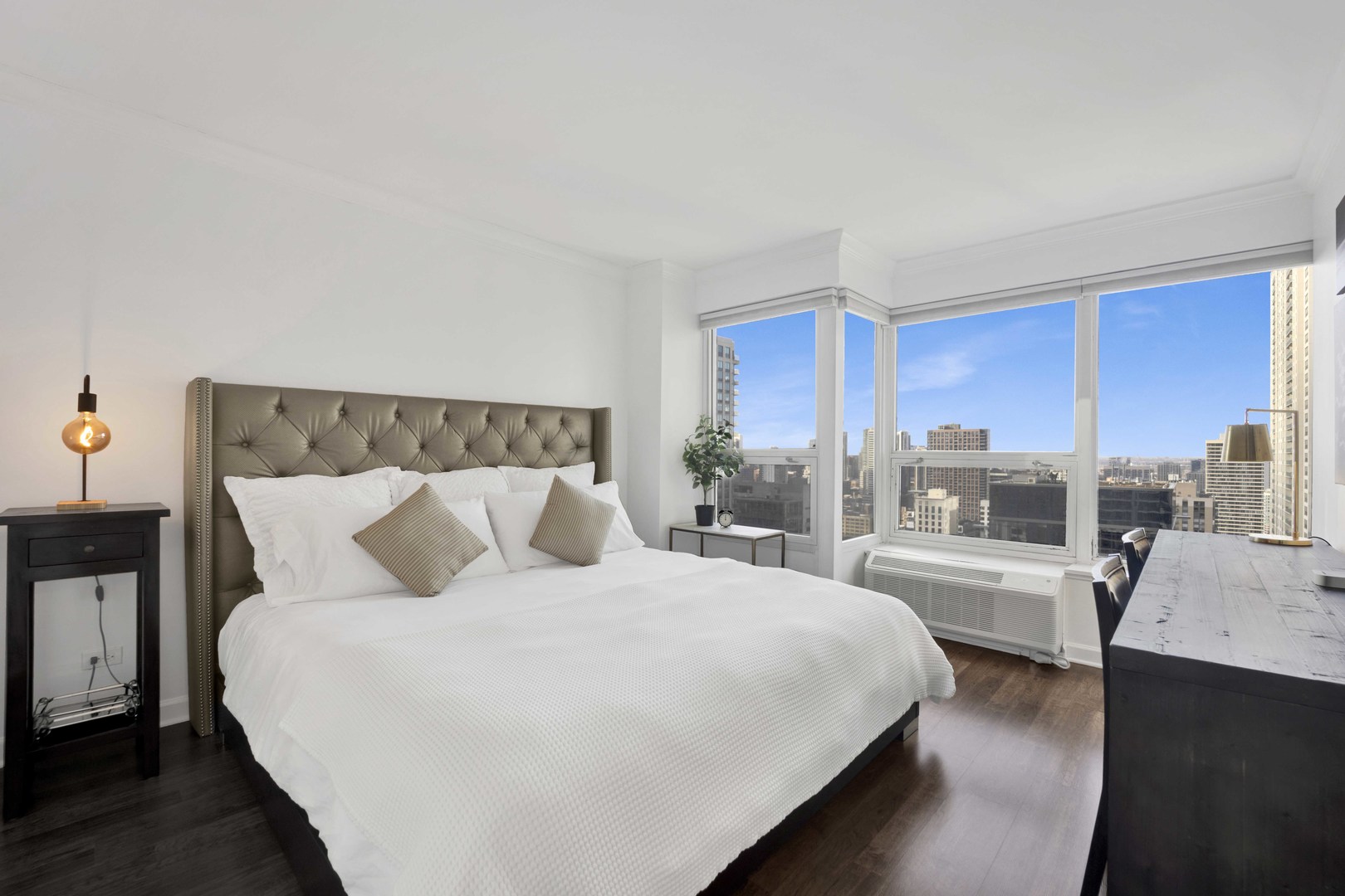 30 East Huron Street, Unit 3206 Chicago, IL 60611 - Photo 10 of 29 a bedroom with a large bed and a wooden floor