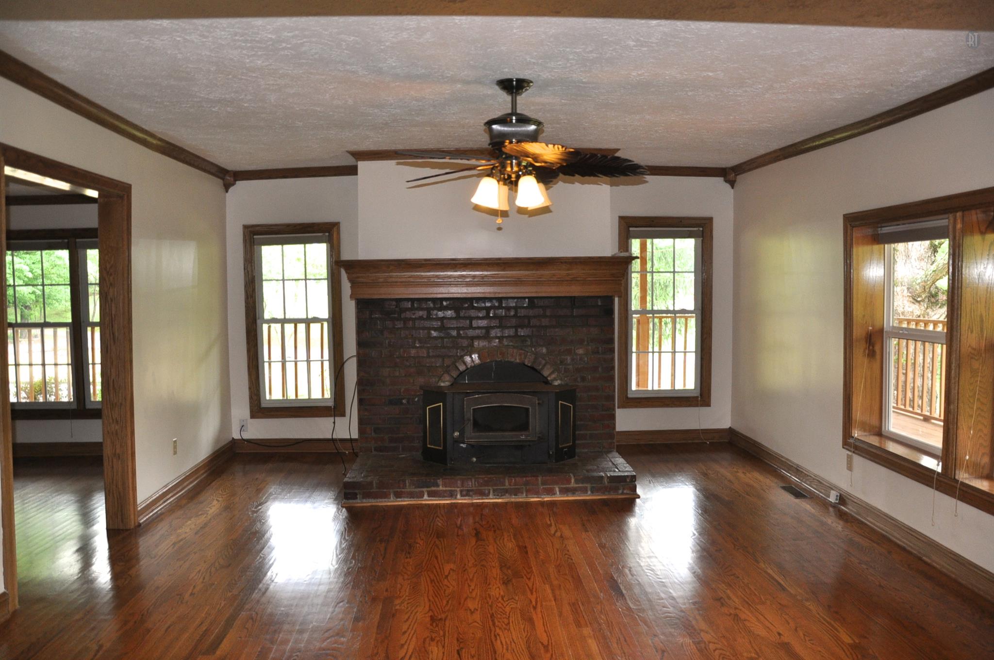 8013 Mill Road Cross Plains, TN 37049 - Photo 15 of 26 wooden floor fireplace and windows in an empty room