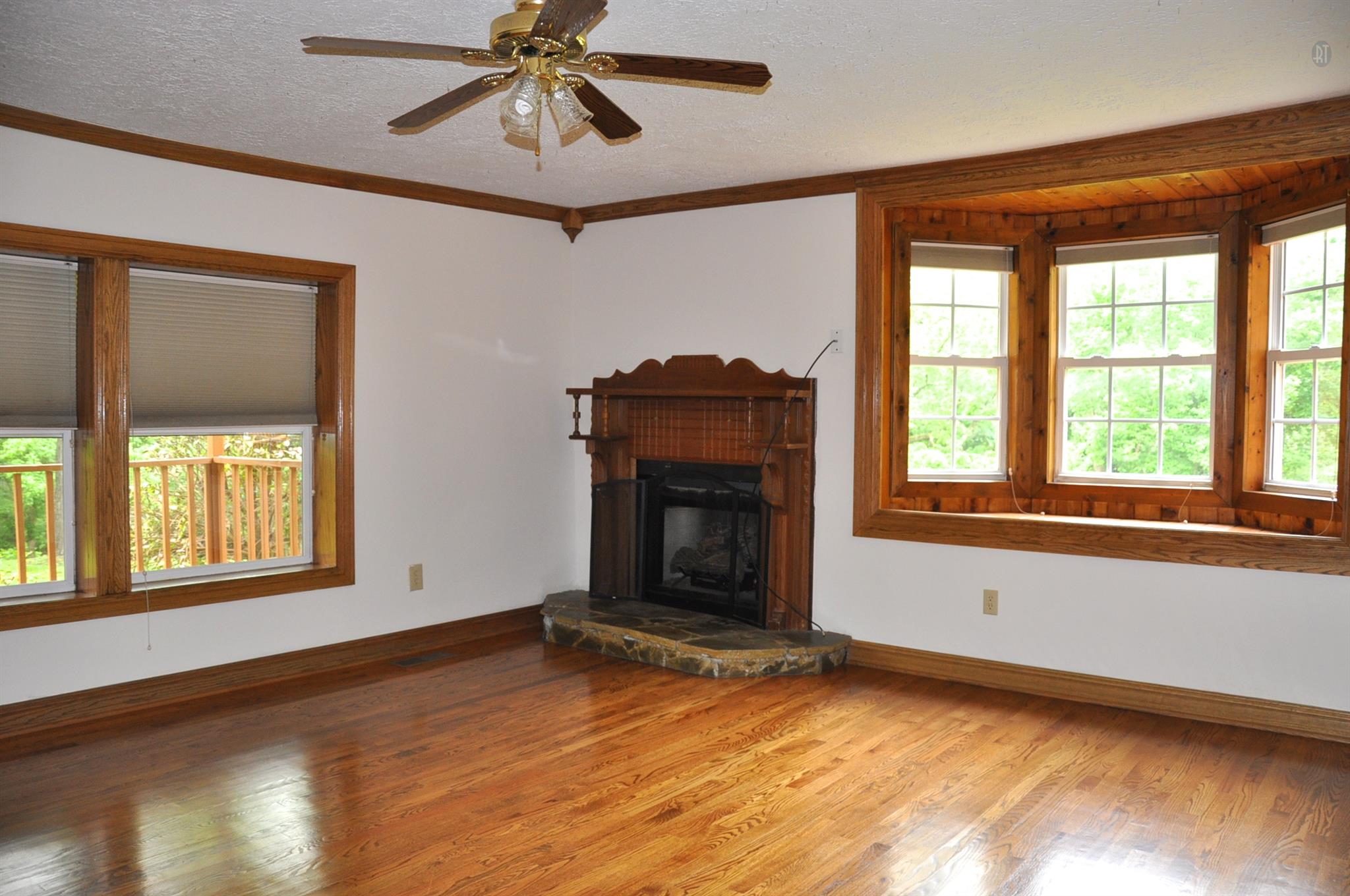 8013 Mill Road Cross Plains, TN 37049 - Photo 17 of 26 a view of an empty room with a window and wooden floor
