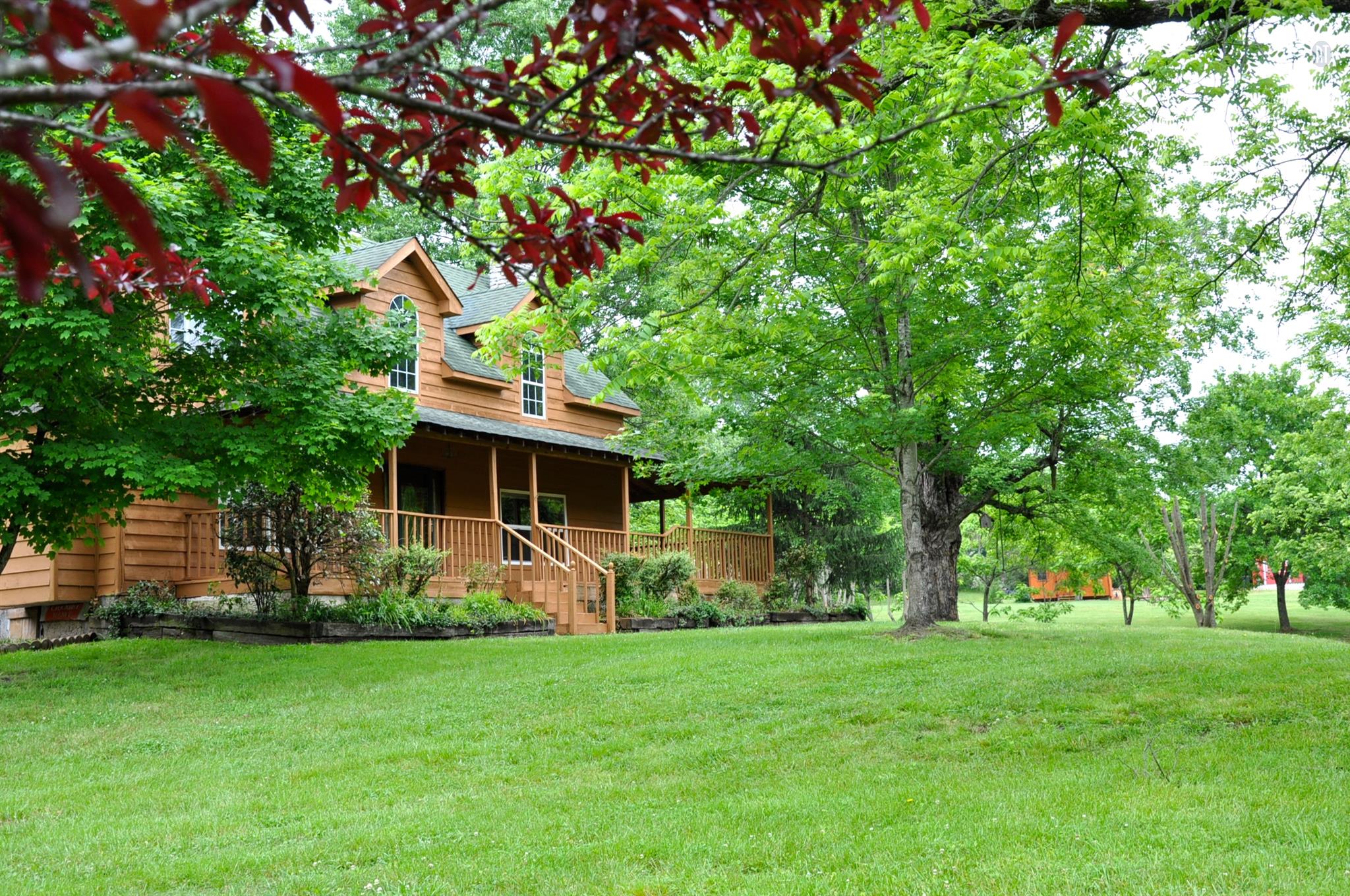 8013 Mill Road Cross Plains, TN 37049 - Photo 4 of 26 a front view of a house with garden
