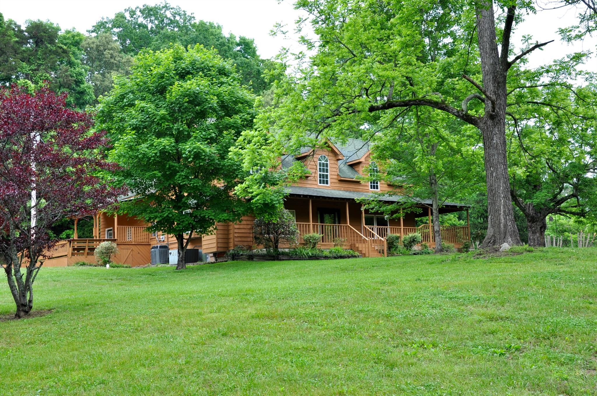 8013 Mill Road Cross Plains, TN 37049 - Photo 7 of 26 a view of a house with a big yard and large trees