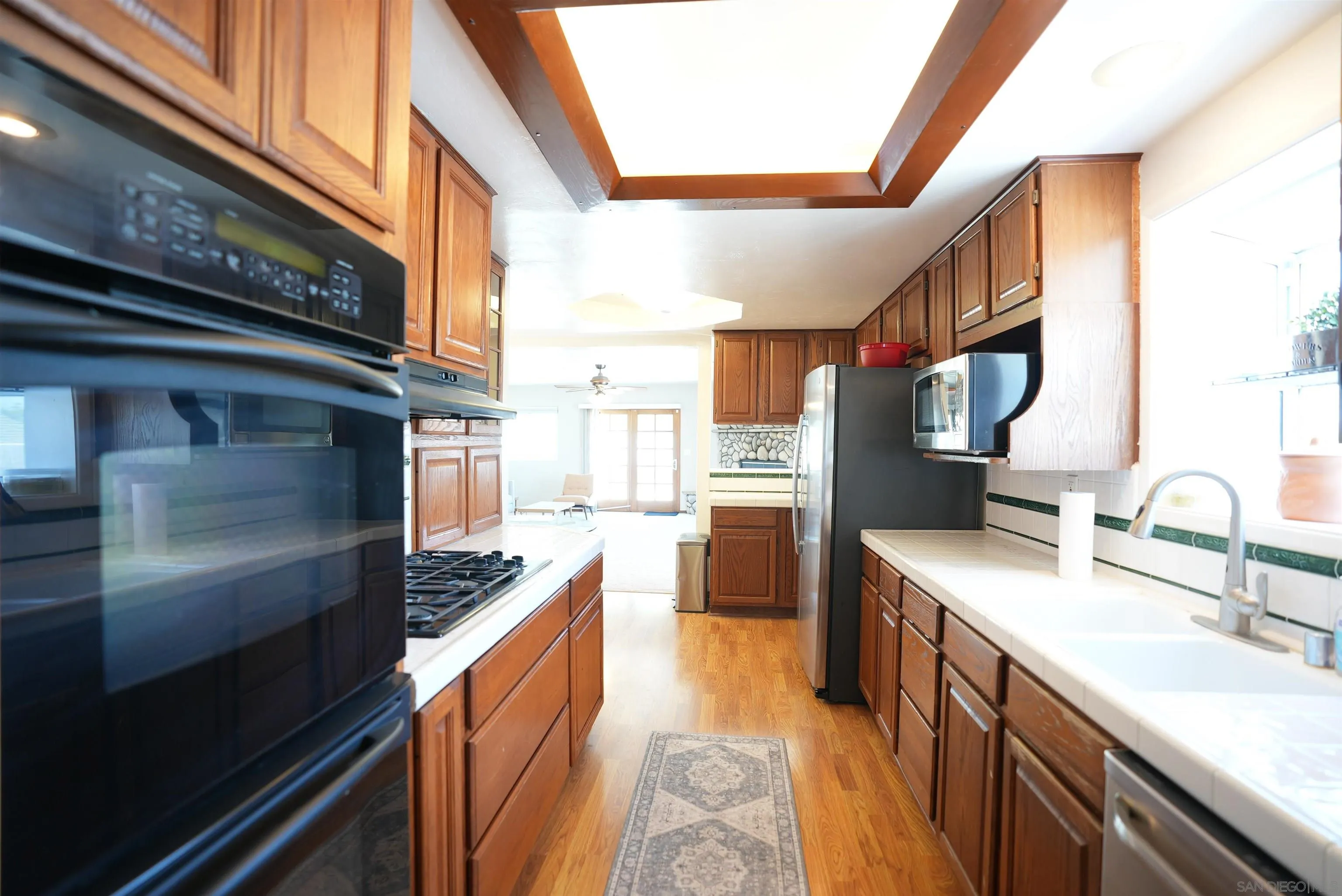 7902 Poplin Drive Santee, CA 92071 - Photo 18 of 59 a kitchen with stainless steel appliances granite countertop sink stove and refrigerator