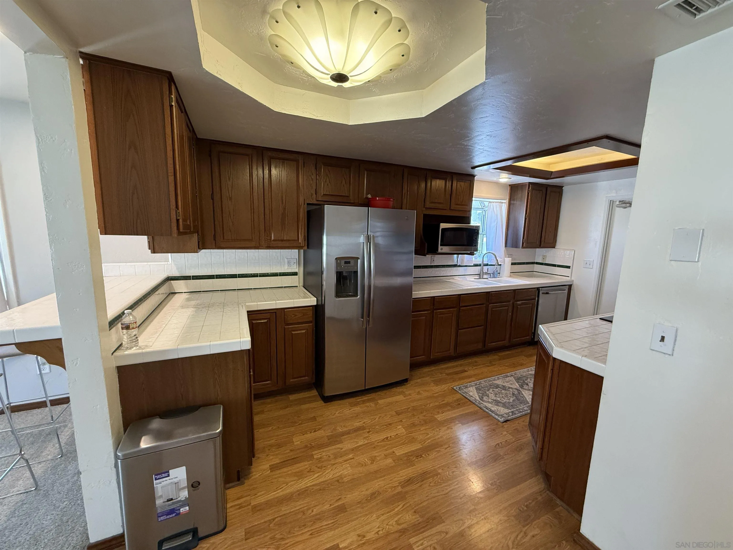 7902 Poplin Drive Santee, CA 92071 - Photo 20 of 59 a kitchen with stainless steel appliances granite countertop a refrigerator a stove and a sink