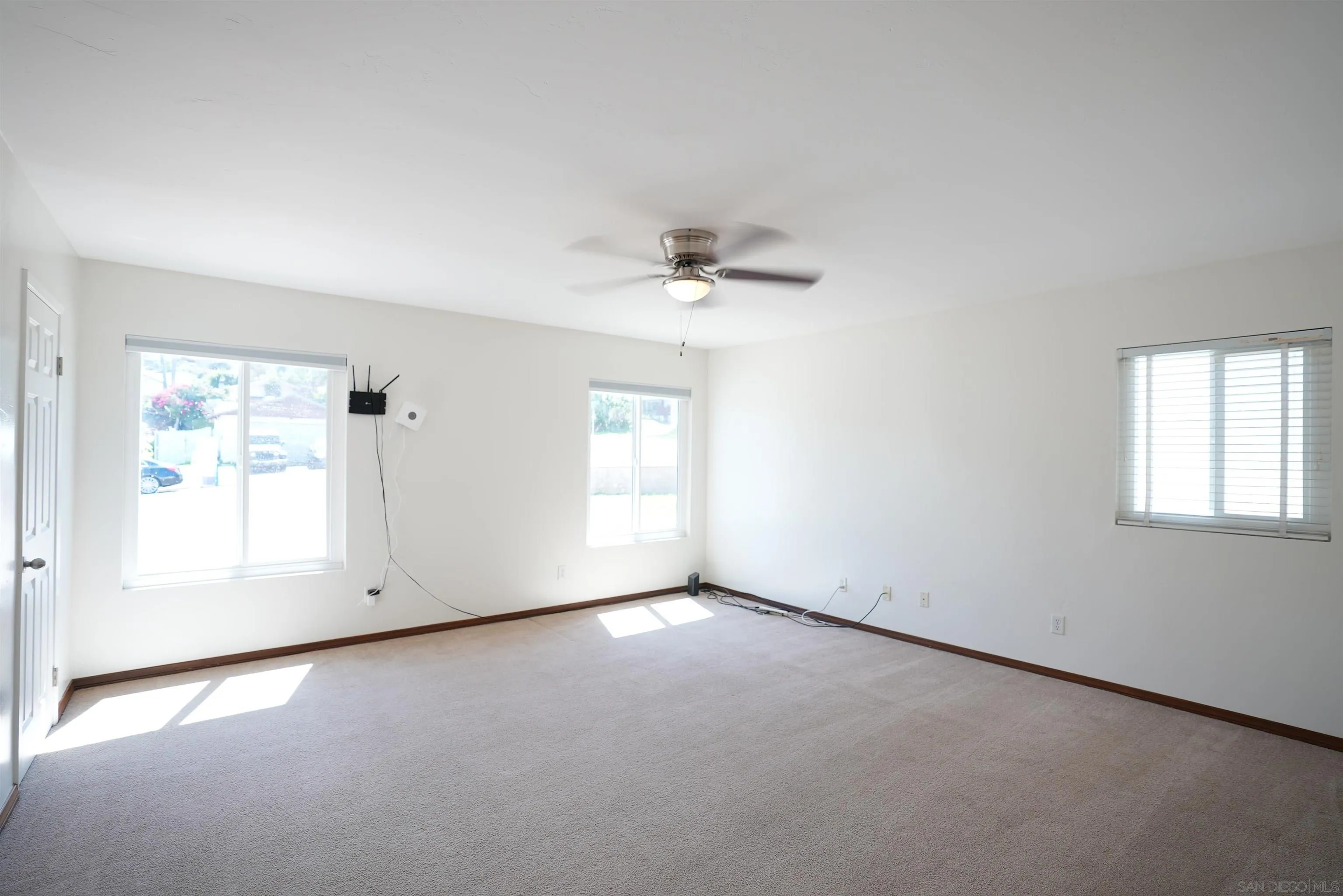7902 Poplin Drive Santee, CA 92071 - Photo 30 of 59 an empty room with a window and a ceiling fan