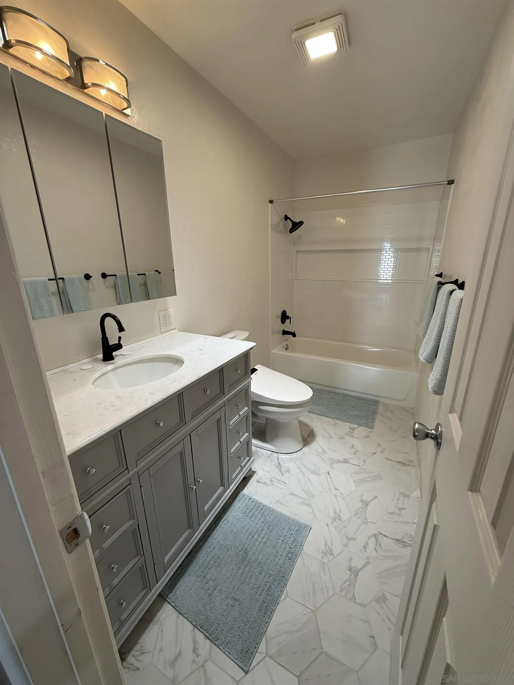 7902 Poplin Drive Santee, CA 92071 - Photo 36 of 59 a bathroom with a sink a toilet and shower