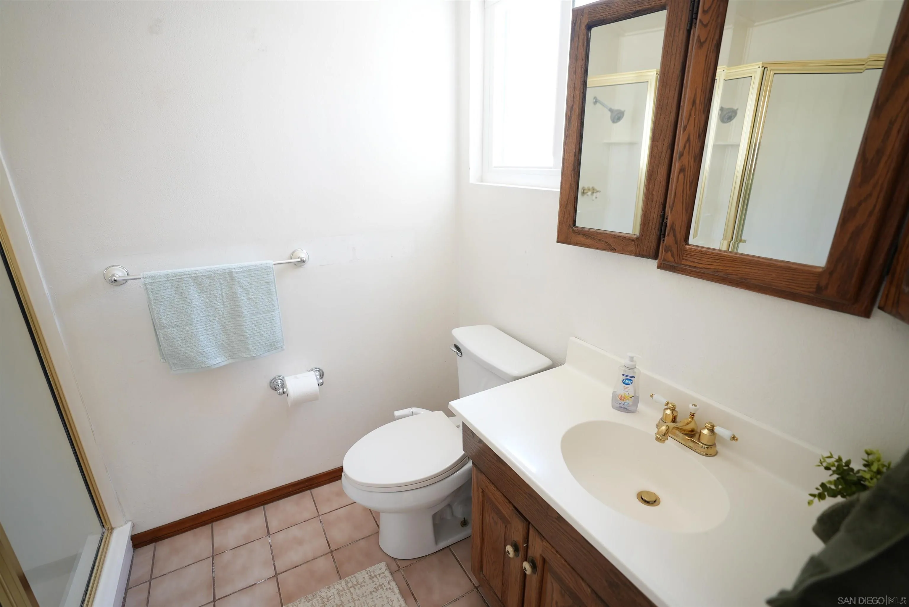 7902 Poplin Drive Santee, CA 92071 - Photo 41 of 59 a white toilet sitting next to a bathroom sink
