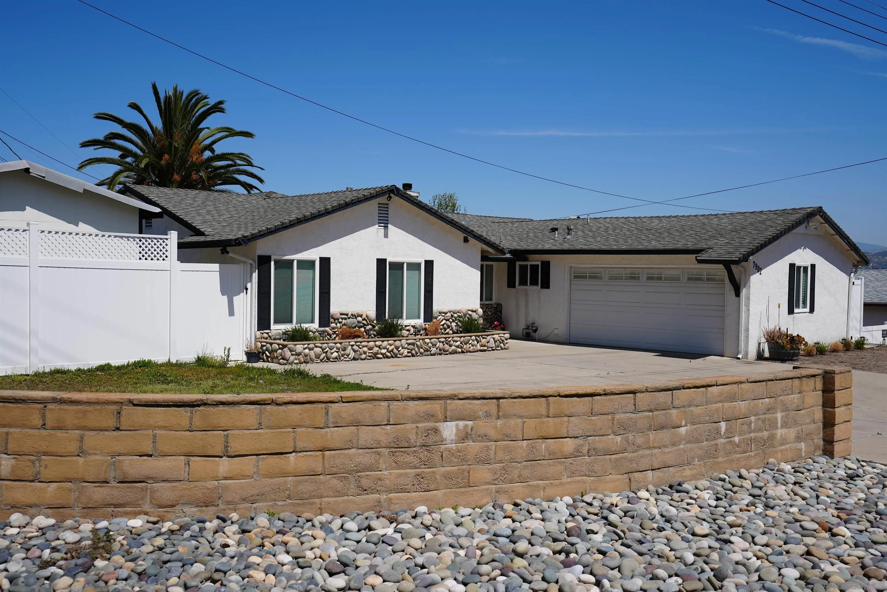 7902 Poplin Drive Santee, CA 92071 - Photo 5 of 59 a front view of a house with a yard