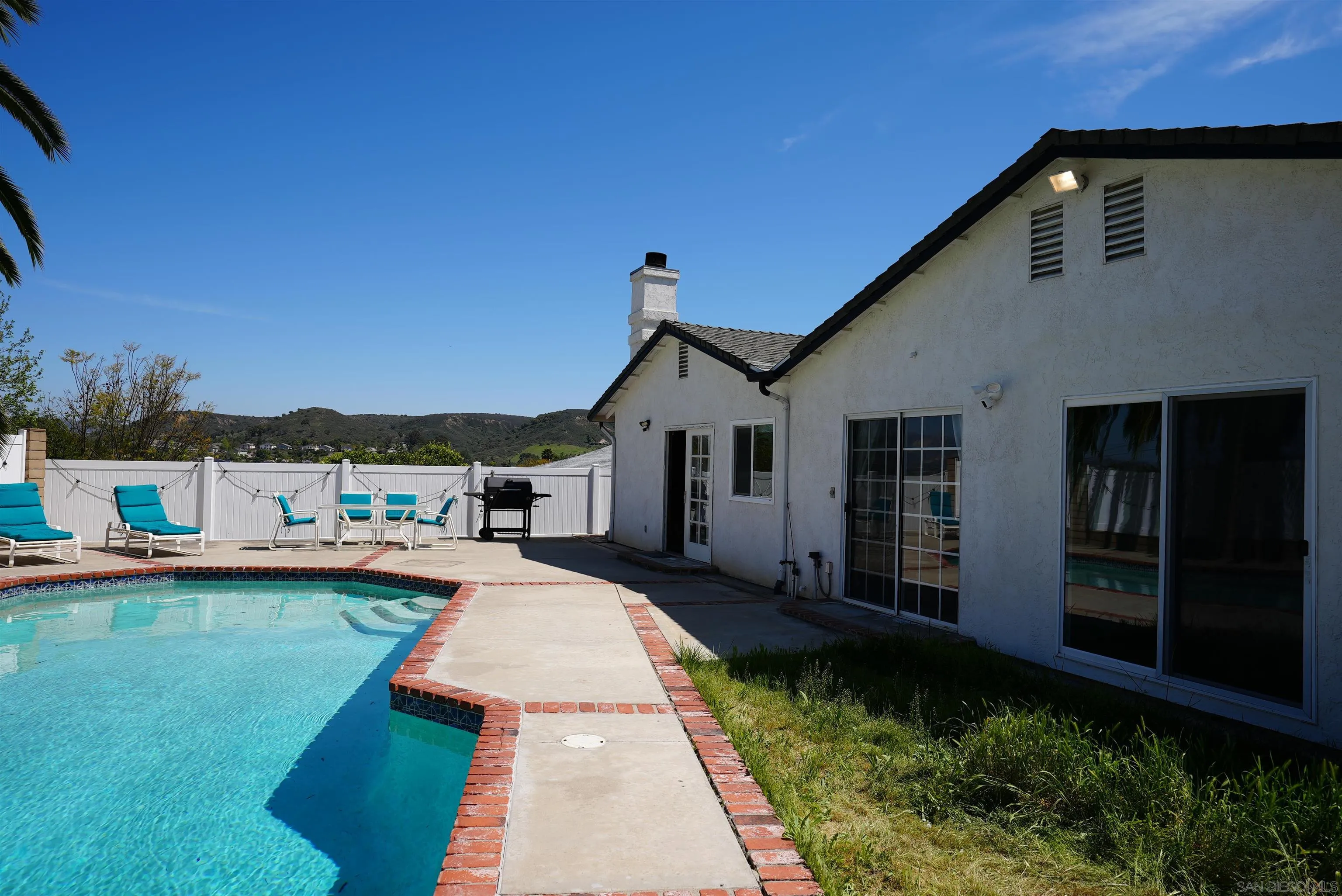 7902 Poplin Drive Santee, CA 92071 - Photo 51 of 59 a front view of a house with swimming pool having outdoor seating