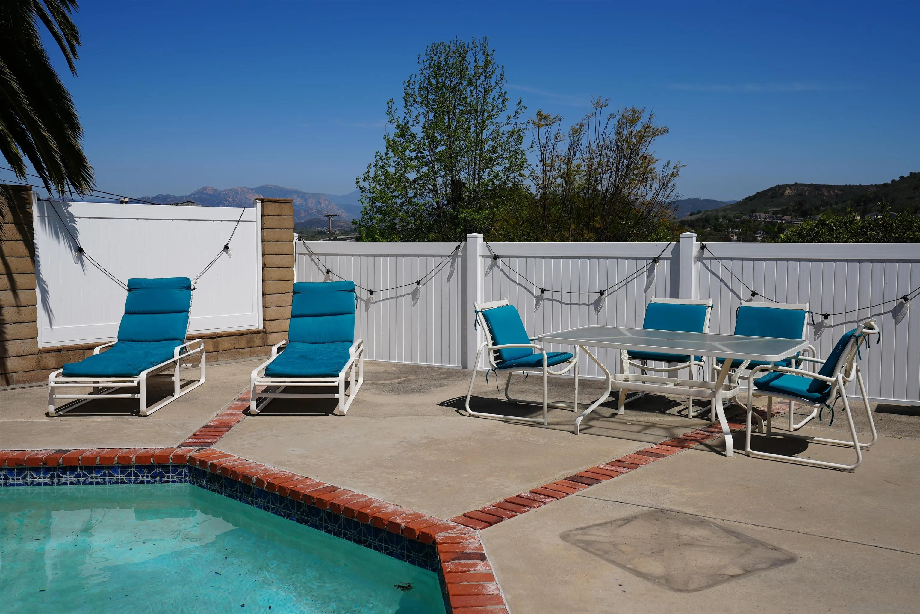 7902 Poplin Drive Santee, CA 92071 - Photo 58 of 59 a roof deck with table and chairs a barbeque and potted plants
