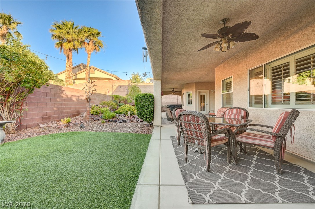 1604 Cattle Ranch Place Henderson, NV 89002 - Photo 66 of 99 Lush landscaping and artificial turf create a vibrant, low-maintenance outdoor sanctuary.