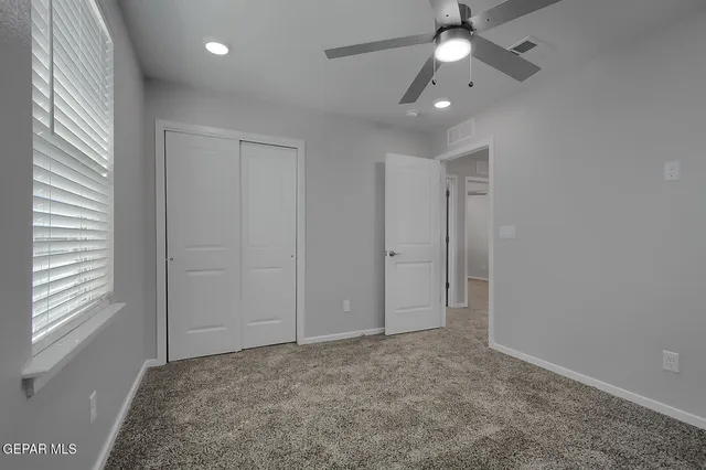 an empty room with a empty space and a ceiling fan