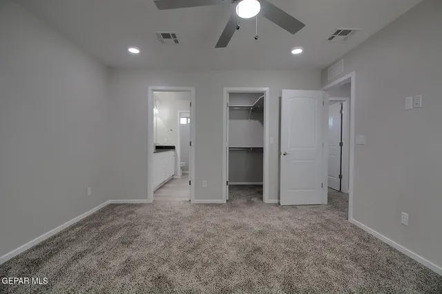 en empty room with fan and window