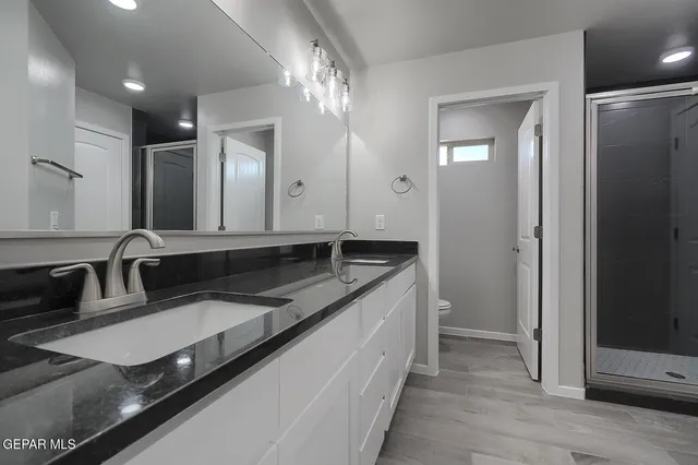 an empty room with a bathroom and a shower