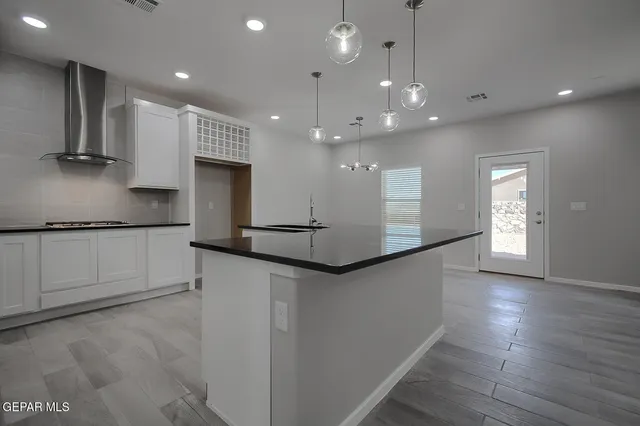 a kitchen with stainless steel appliances granite countertop a refrigerator a sink and a oven