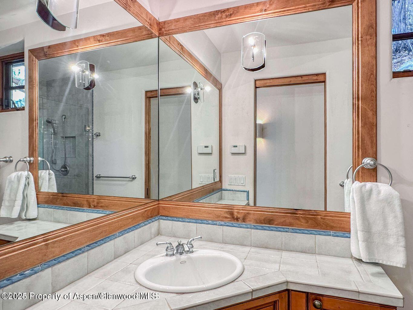 1540 Silver King Drive Aspen, CO 81611 - Photo 25 of 32 a bathroom with a sink and a mirror
