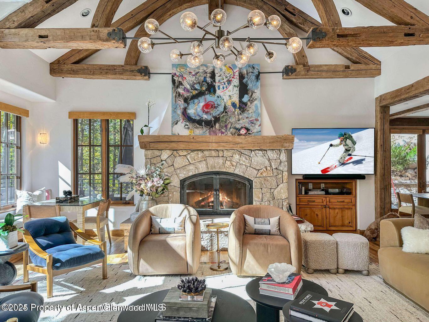 1540 Silver King Drive Aspen, CO 81611 - Photo 3 of 32 a living room with furniture a fireplace and a table