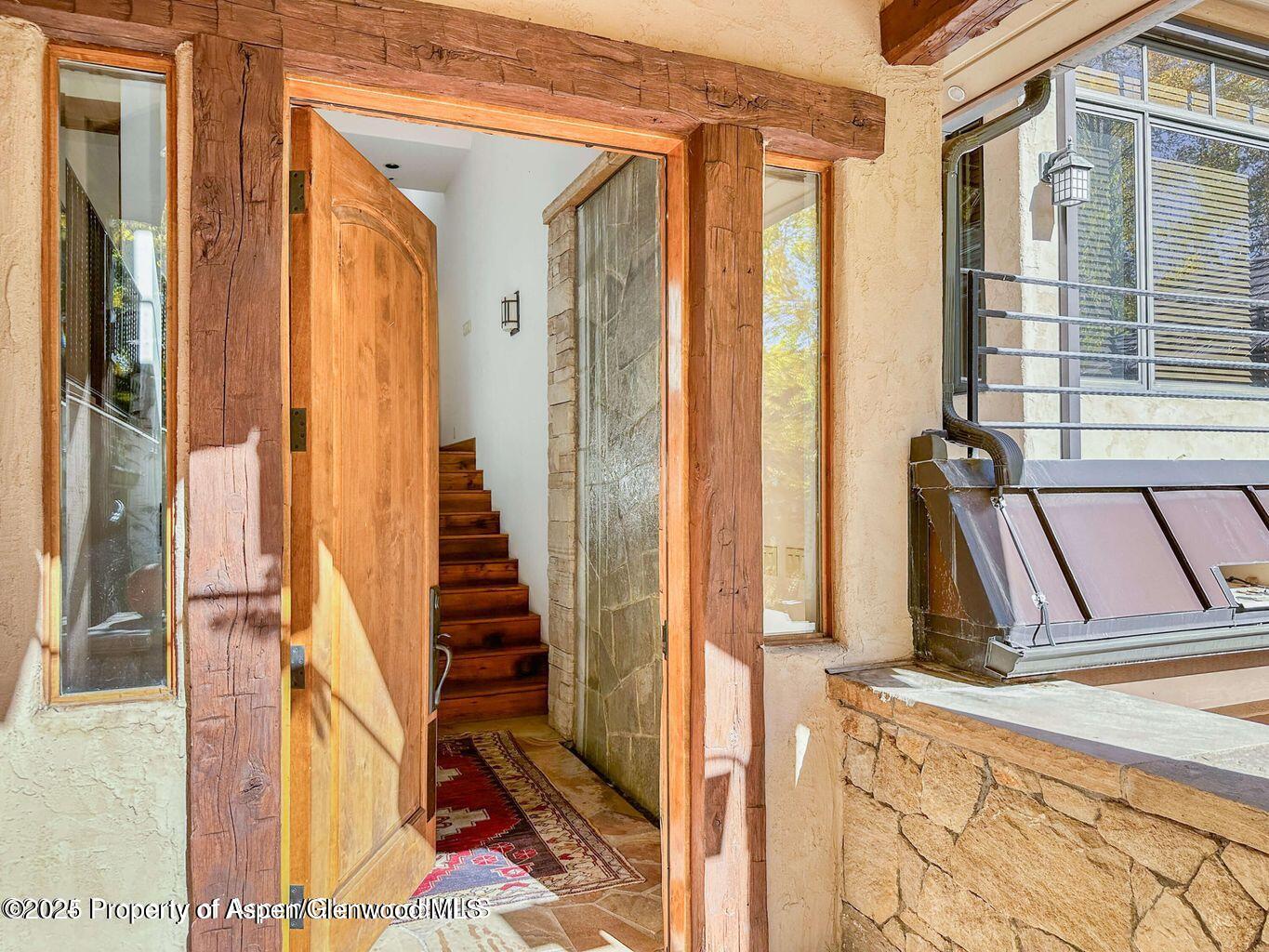 1540 Silver King Drive Aspen, CO 81611 - Photo 4 of 32 a view of a balcony with furniture and floor to ceiling window