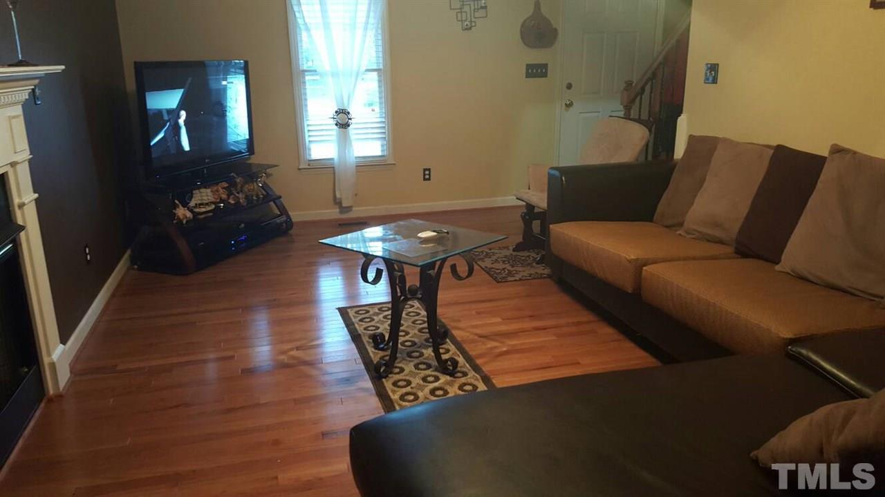 4401 Wolftrap Road Raleigh, NC 27616 - Photo 11 of 18 a living room with furniture and a potted plant