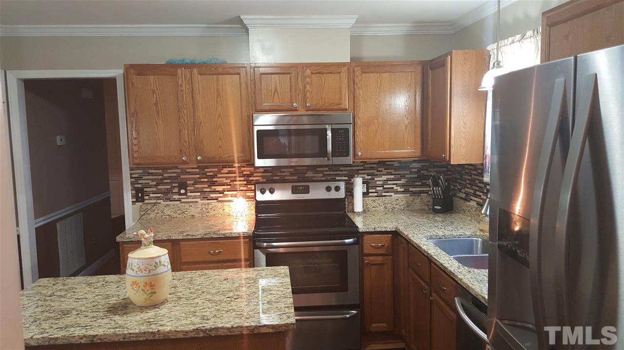 4401 Wolftrap Road Raleigh, NC 27616 - Photo 6 of 18 a kitchen with stainless steel appliances granite countertop a refrigerator and a stove