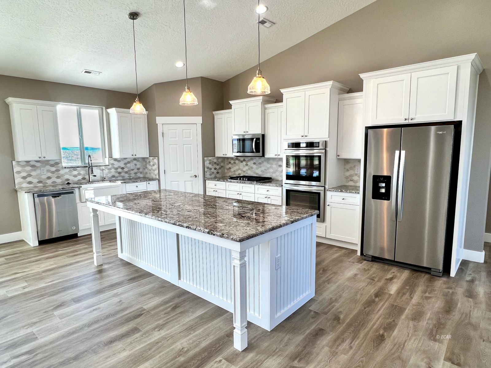 457 Sun Vly Road Spring Creek, NV 89815 - Photo 2 of 33 a large kitchen with stainless steel appliances kitchen island granite countertop a large counter top a stove a sink and a refrigerator