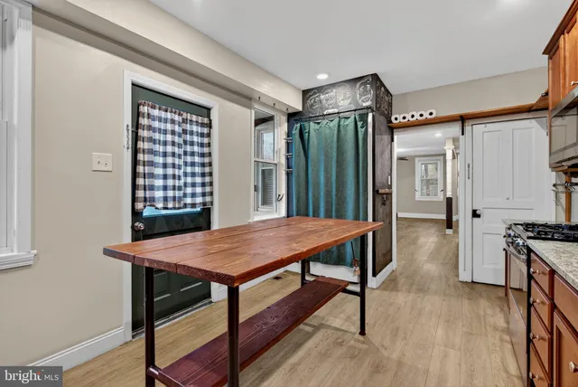 a kitchen with a stove a sink and a refrigerator