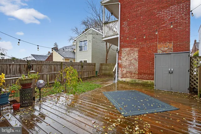 a view of a house with a tree and wooden fence