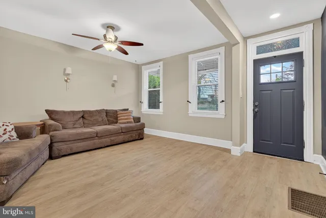a living room with furniture and stairs