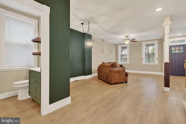 a bathroom with a sink a toilet and a mirror