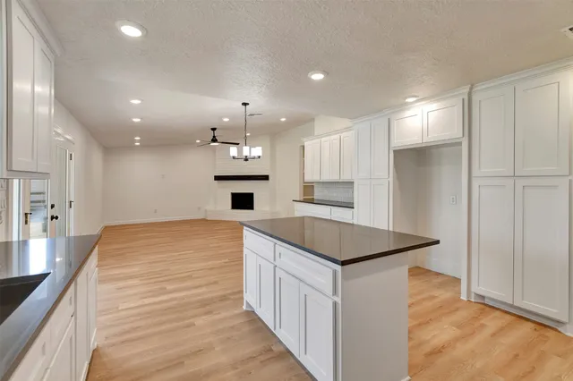 a kitchen with kitchen island a sink stainless steel appliances and cabinets