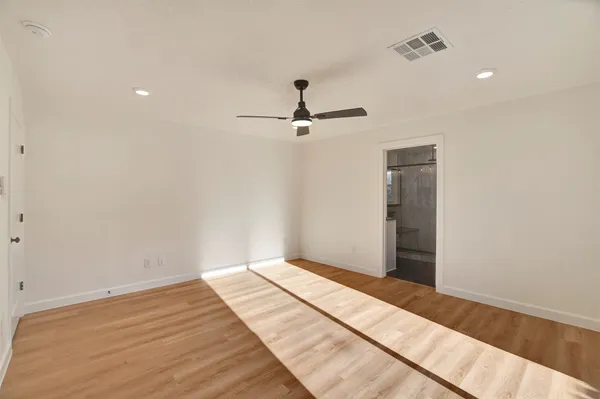 a view of an empty room with sliding glass door